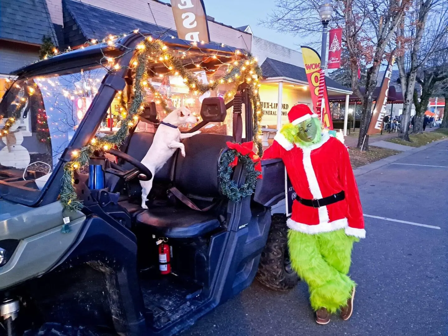 A person dressed as santa clause and a grinch